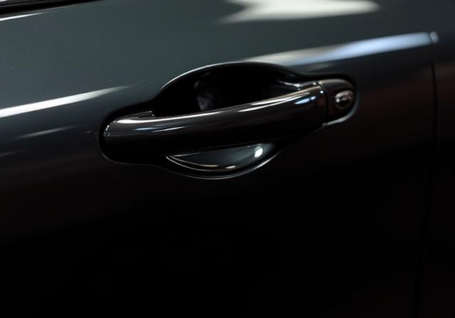 The same black car door now with a flawless, deep mirror finish, free of imperfections.
